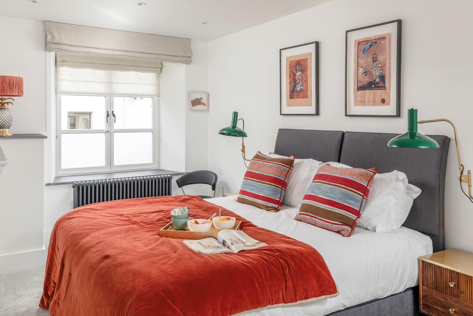 The colourful second bedroom is flooded with natural light, and can be set up as a king size bed or twin beds.