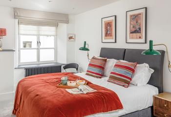 The colourful second bedroom is flooded with natural light, and can be set up as a king size bed or twin beds.