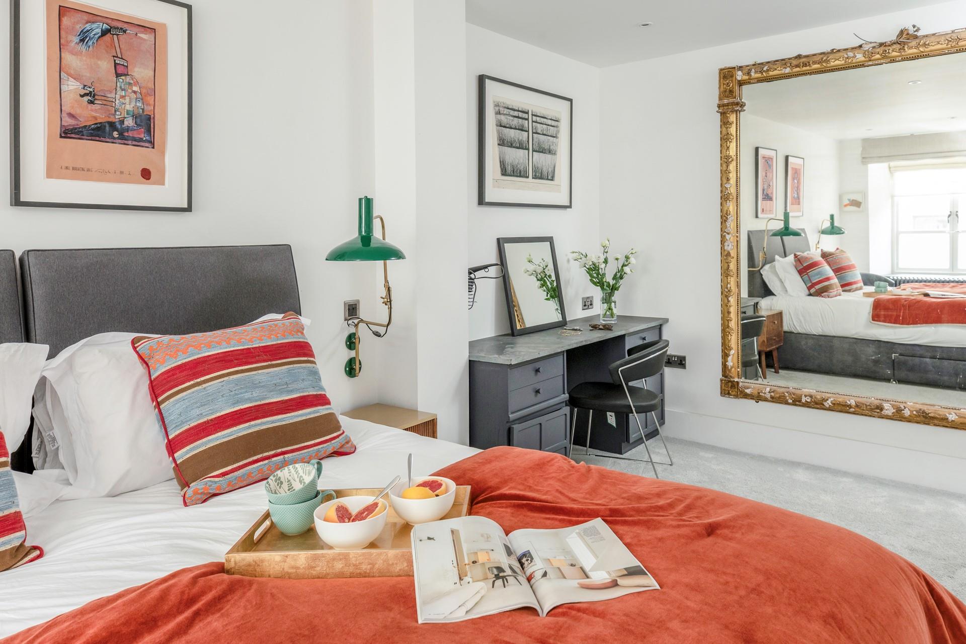 The bedroom is spacious and stylishly decorated.