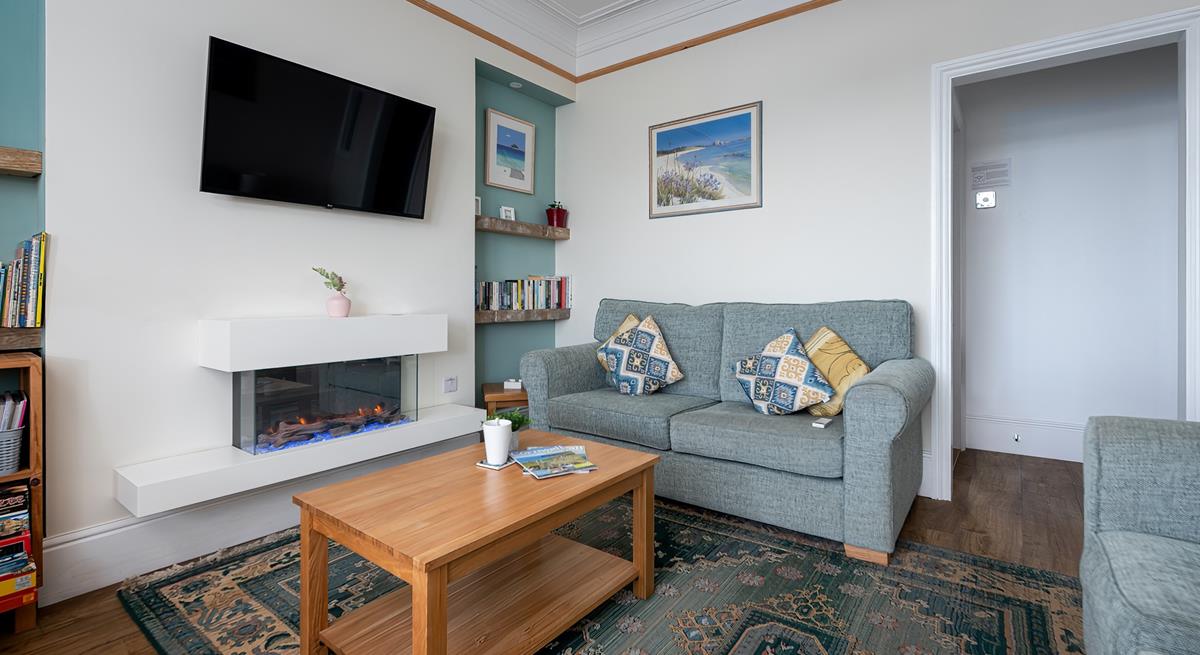 We love the modern fireplace and coastal artwork in the sitting room. 