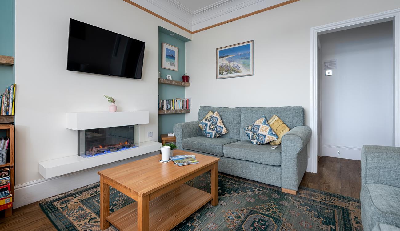 We love the modern fireplace and coastal artwork in the sitting room. 