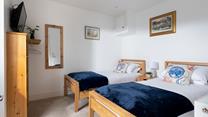 Suitable for children or friends, bedroom 2 offers twin beds and access to the rear courtyard.