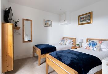 Suitable for children or friends, bedroom 2 offers twin beds and access to the rear courtyard.