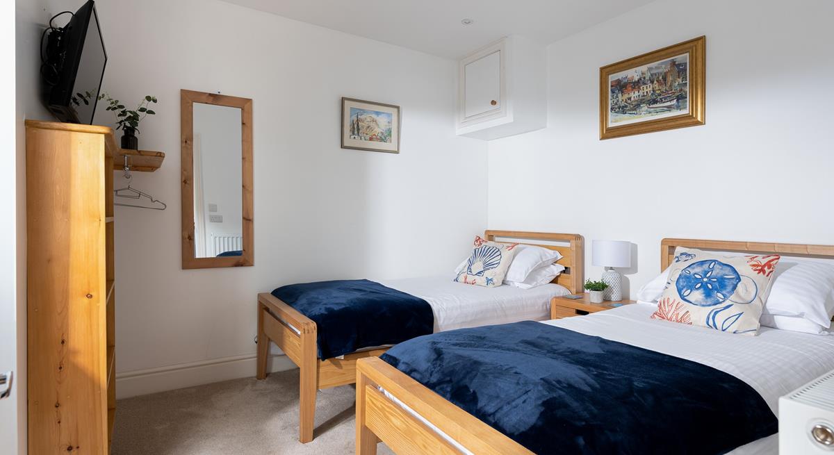 Suitable for children or friends, bedroom 2 offers twin beds and access to the rear courtyard.