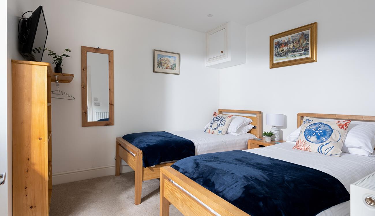 Suitable for children or friends, bedroom 2 offers twin beds and access to the rear courtyard.