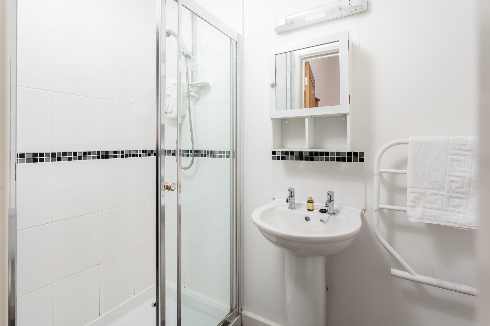 Bedroom 1 benefits from an en suite shower room, providing convenience and privacy for guests. 