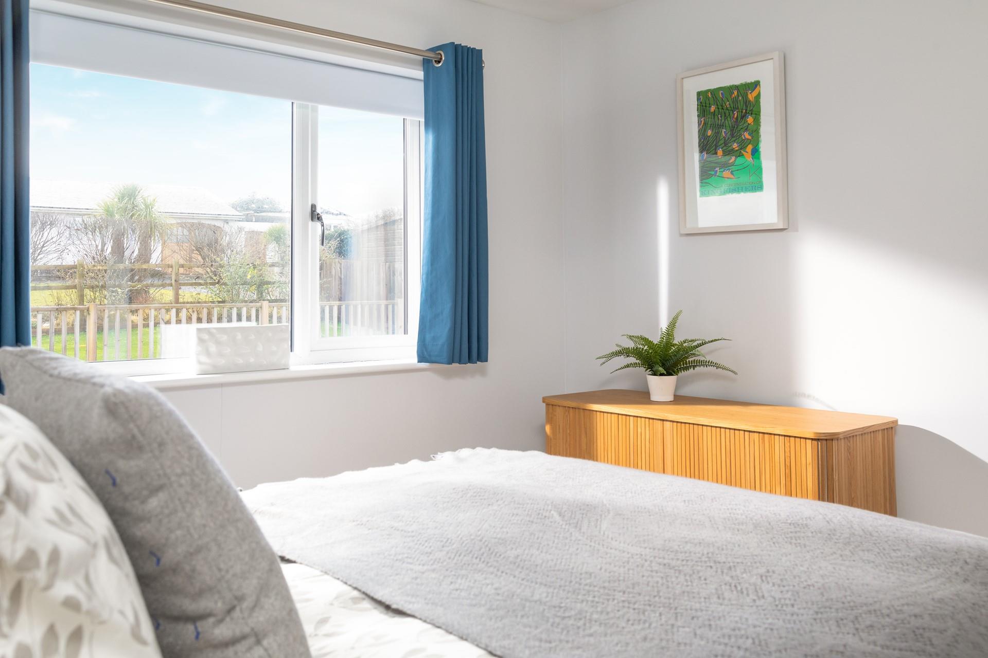 Bedroom 2 has calming grey tones making for a comfortable space to unwind.