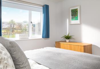 Bedroom 2 has calming grey tones making for a comfortable space to unwind.