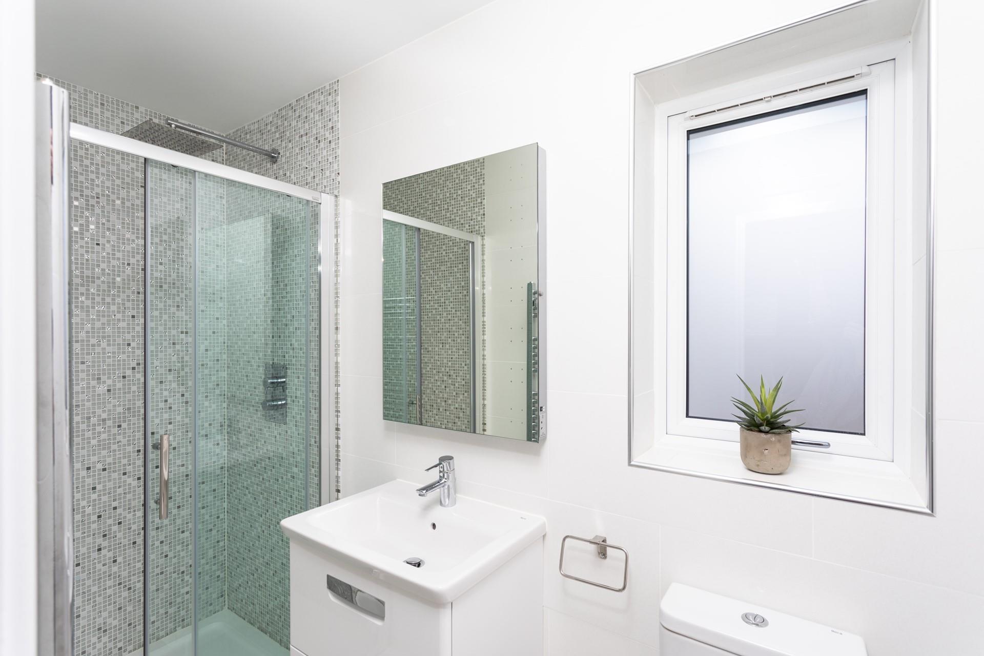 Bedroom 1 has a luxurious rainfall shower to wake you up in the morning.