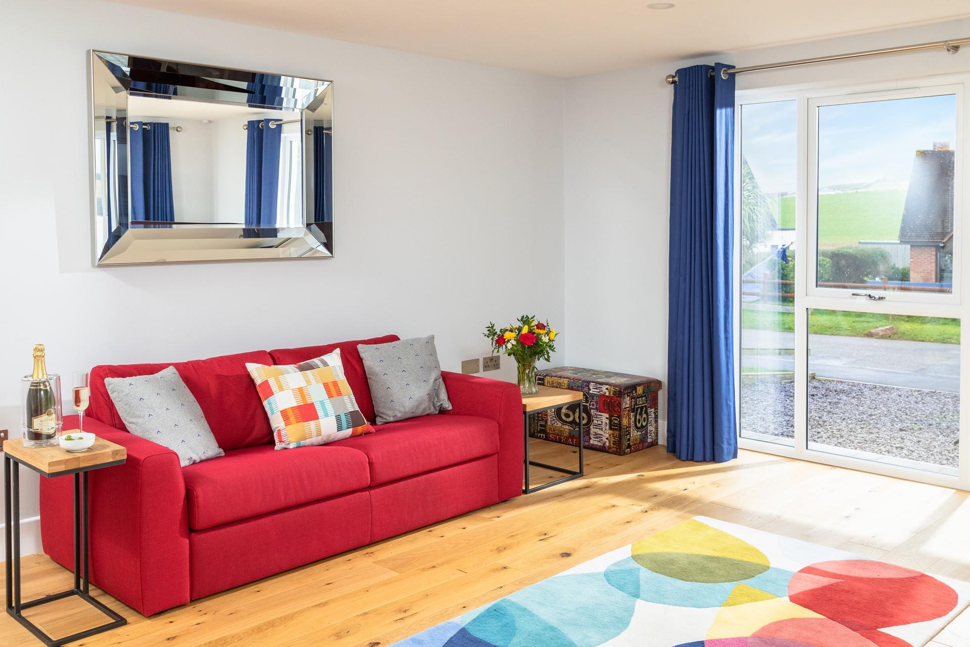 The sitting room has views over the coastal countryside, sit and relax while enjoying your favourite tipple.