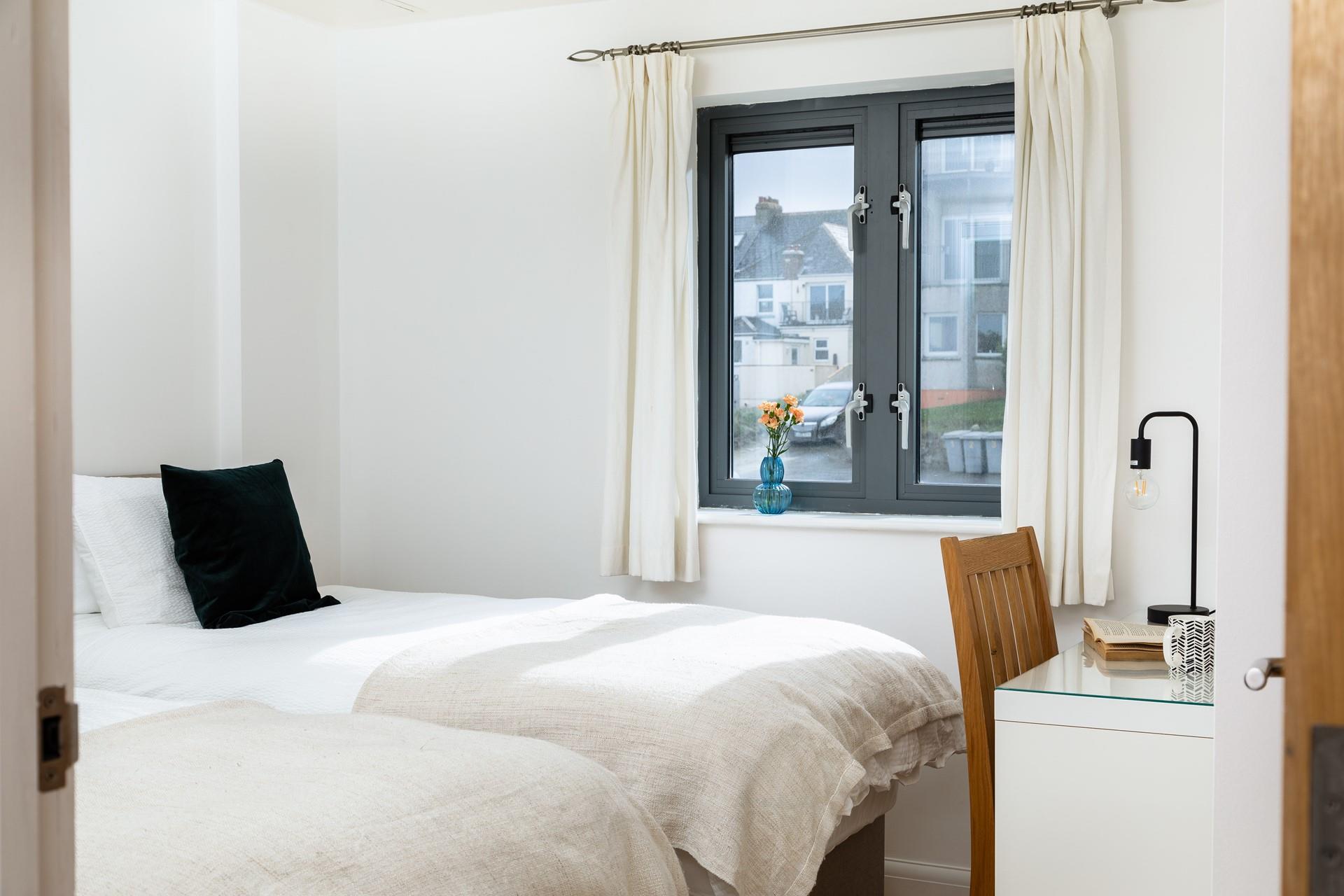 The twin bedroom is light and airy and finished in calming tones. 