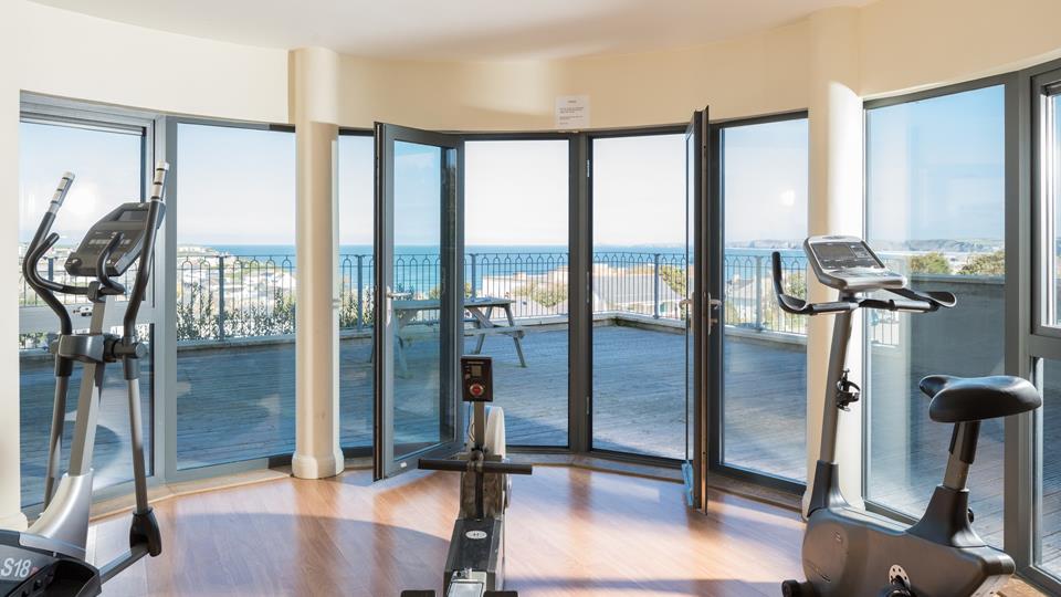 The communal gym is also available for guests' use, and offers views across Newquay. 