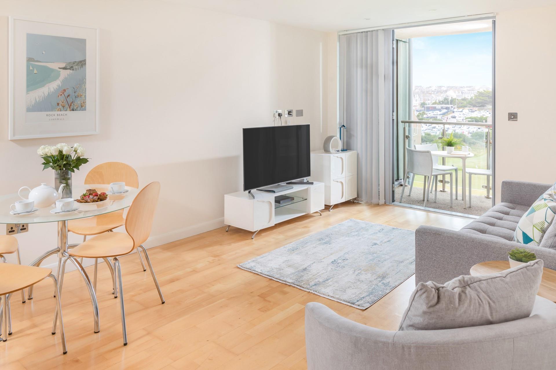 Step out from the living area onto the balcony to enjoy the surrounding views.