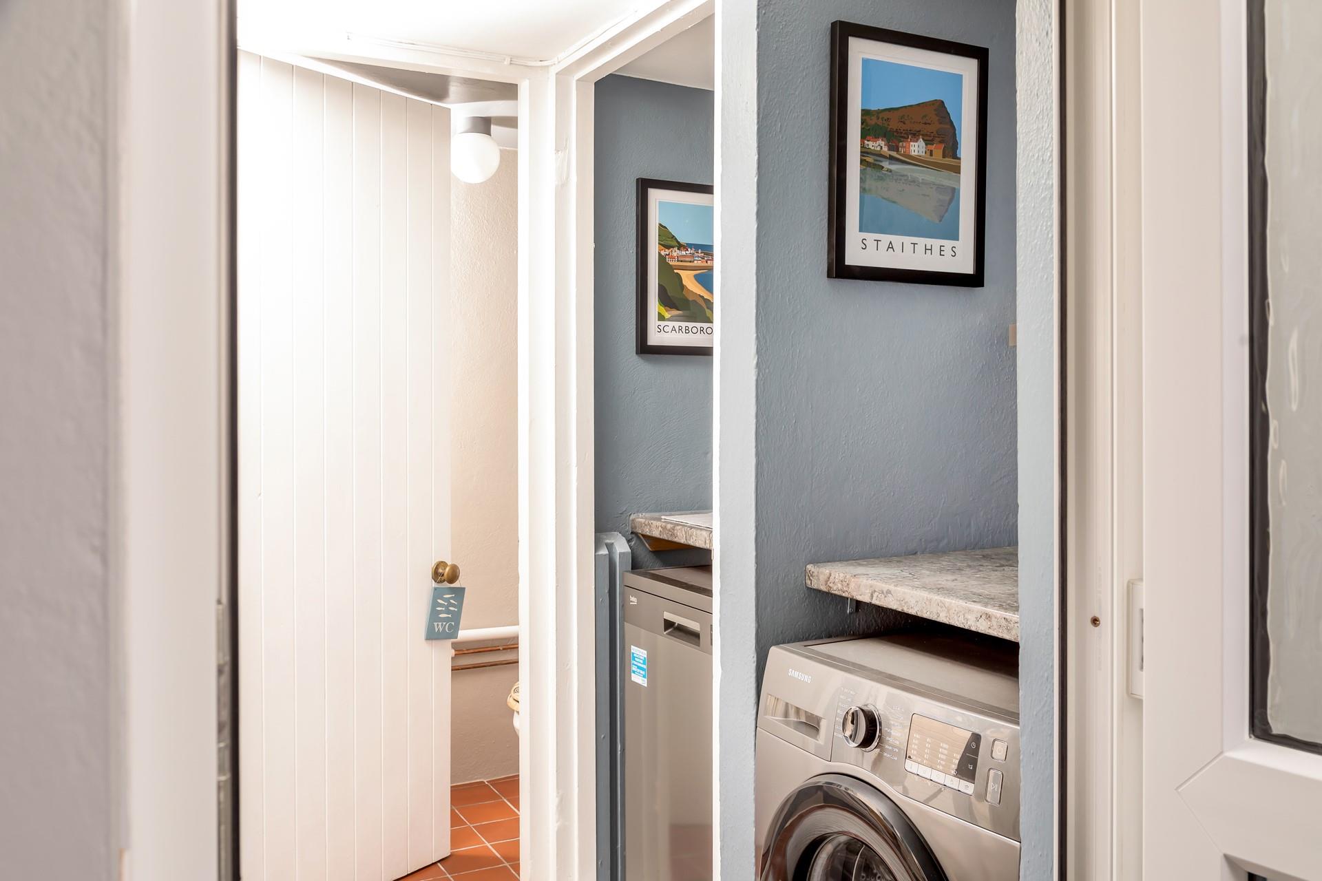 The utility leads to the downstairs cloakroom. 