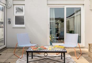 Enjoy a board game in the garden, lounging on the stylish chairs. 