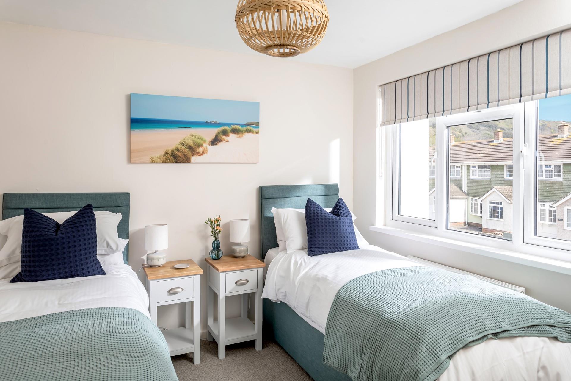 We love the coastal colours and décor in the bright twin room. 