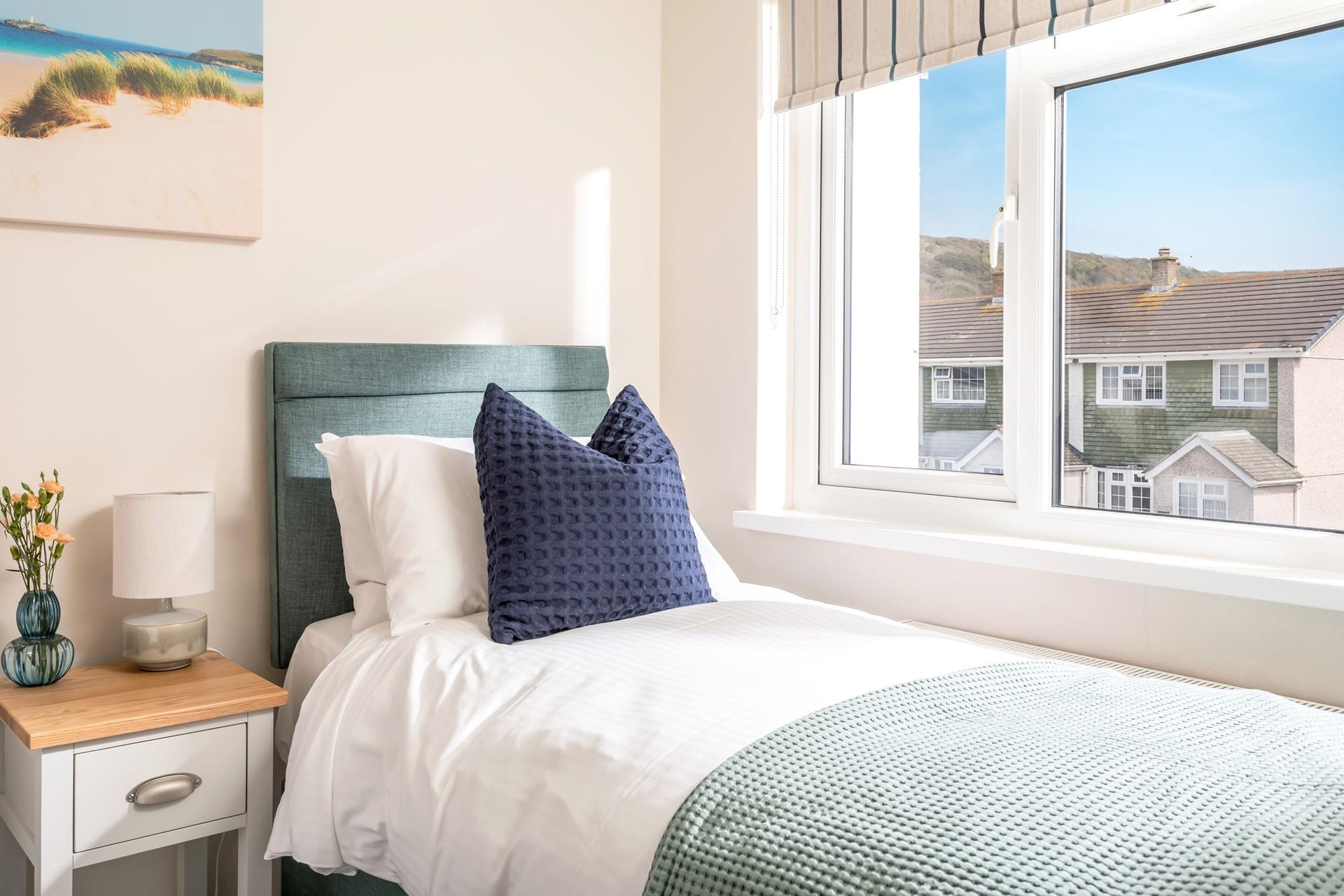 Sink into the sumptuous bed, admiring the coastal views beyond the houses. 