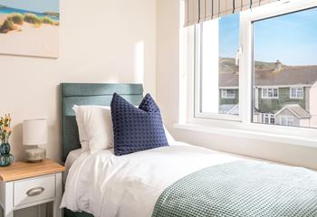 Sink into the sumptuous bed, admiring the coastal views beyond the houses. 
