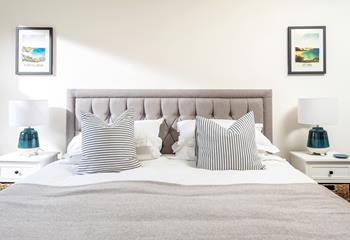 Crisp white linen and plump cushions promise a dreamy night's sleep. 