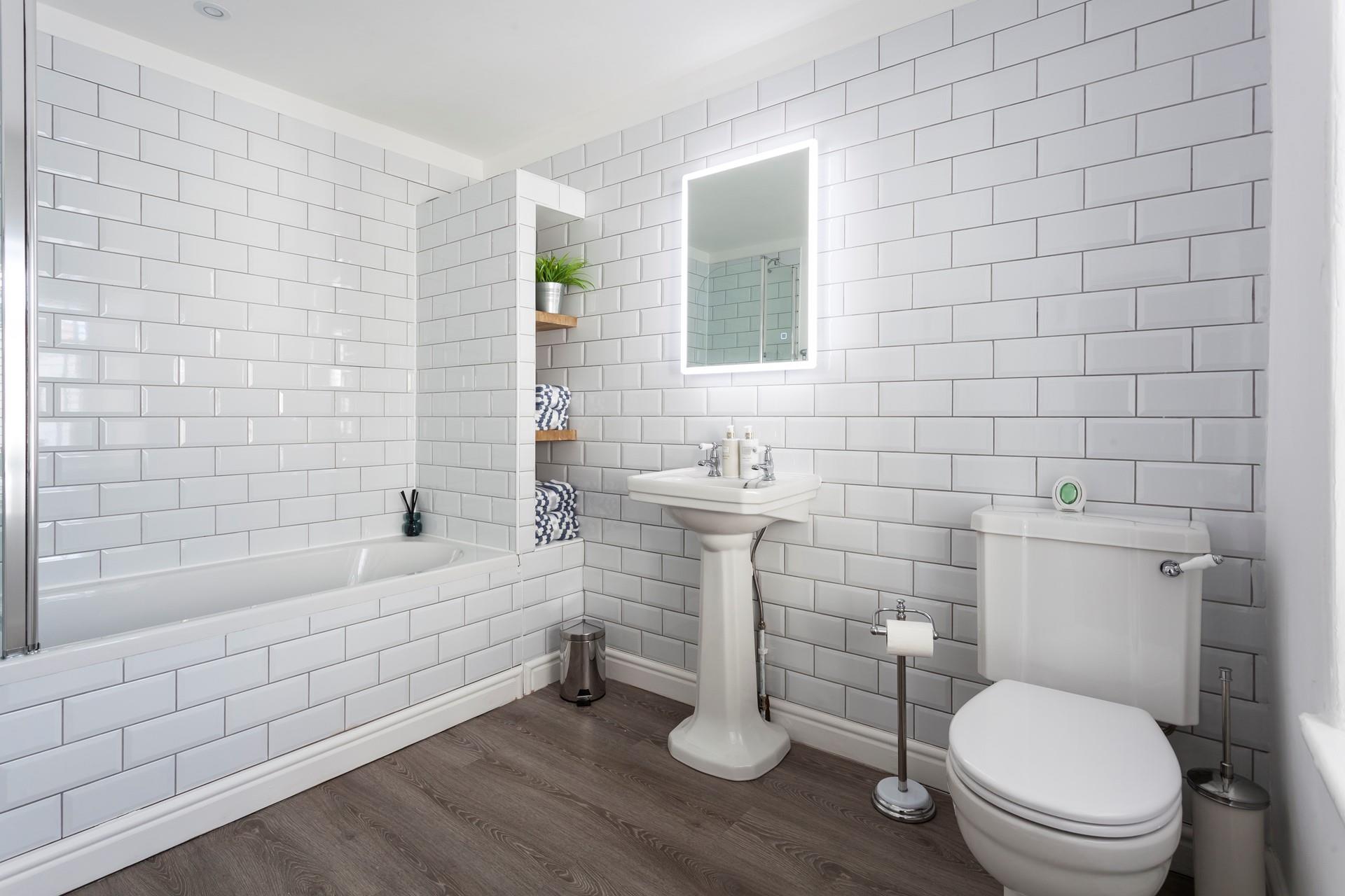 The bathroom is spacious and modern with ample room to get ready.