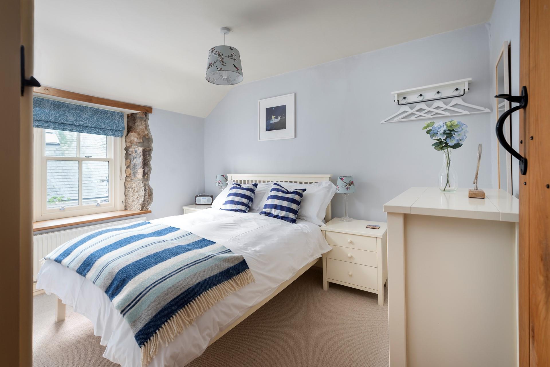 Light and airy, bedroom 1 is beautifully finished in calming blues and whites, perfect for its seaside location. 
