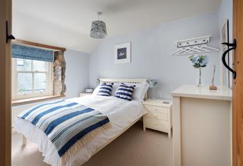 Light and airy, bedroom 1 is beautifully finished in calming blues and whites, perfect for its seaside location. 