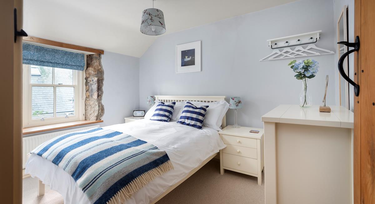 Light and airy, bedroom 1 is beautifully finished in calming blues and whites, perfect for its seaside location. 