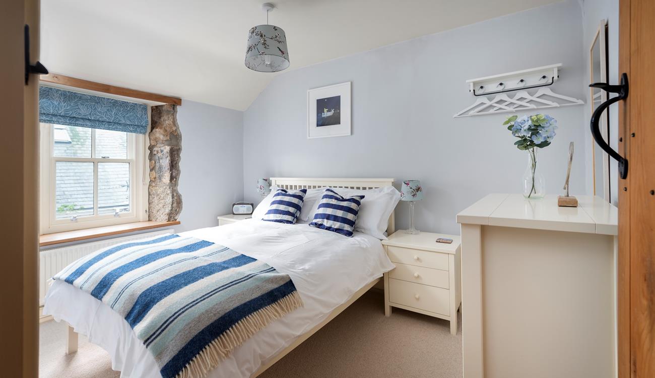 Light and airy, bedroom 1 is beautifully finished in calming blues and whites, perfect for its seaside location. 