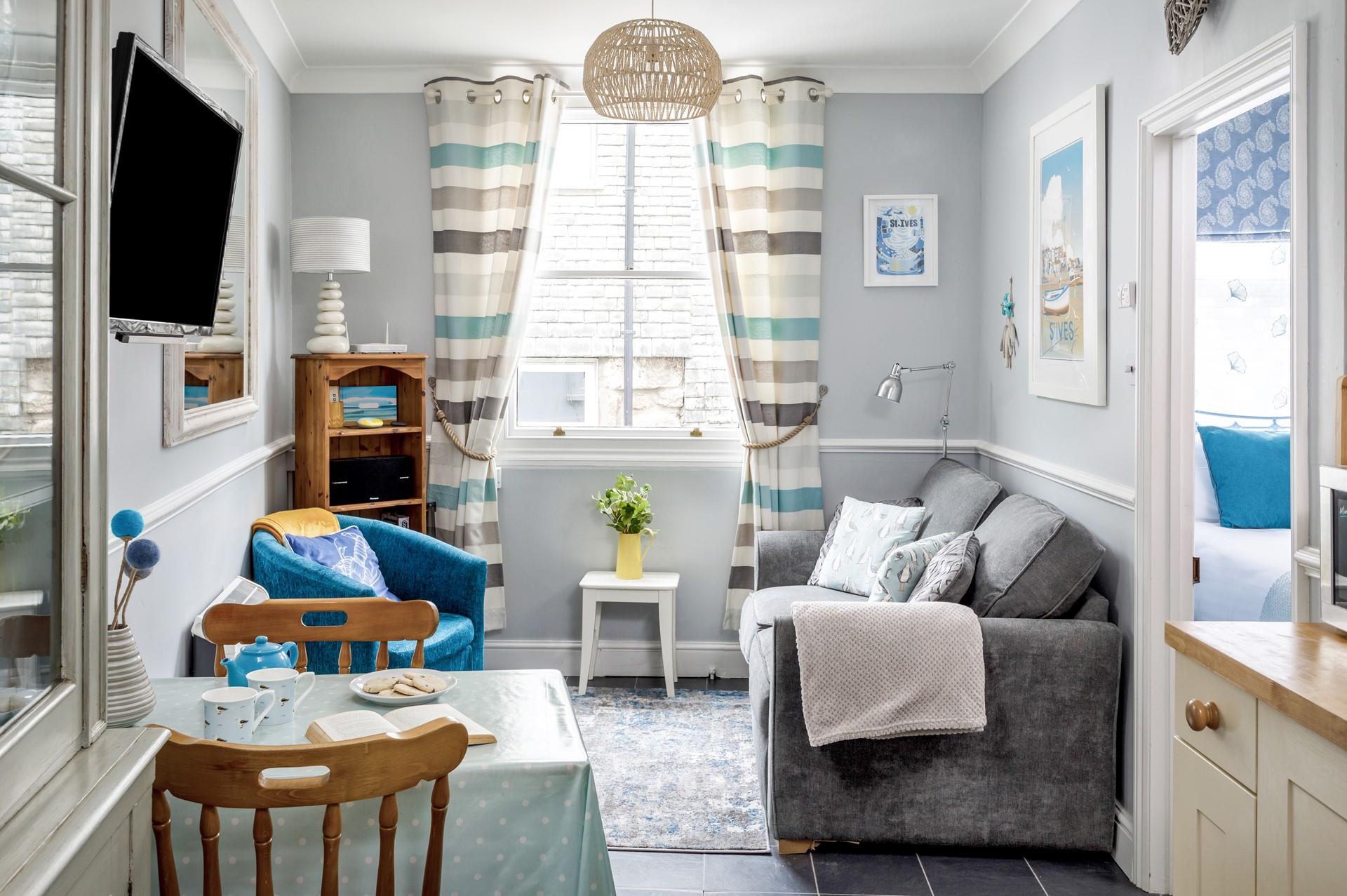 Snug and cosy, the sitting room is the perfect place to relax after a day exploring St Ives. 
