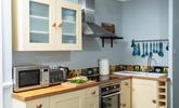 Finished in cream and pastel blues, with slate flooring, the kitchen has a countryside vibe.  - Thumbnail Image
