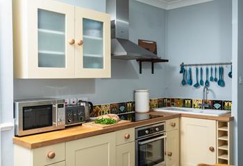 Finished in cream and pastel blues, with slate flooring, the kitchen has a countryside vibe. 