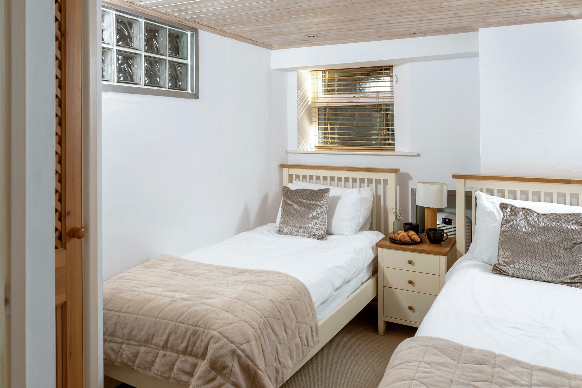 Decorated in calming neutral shades, the twin room promises a relaxing night's sleep. 