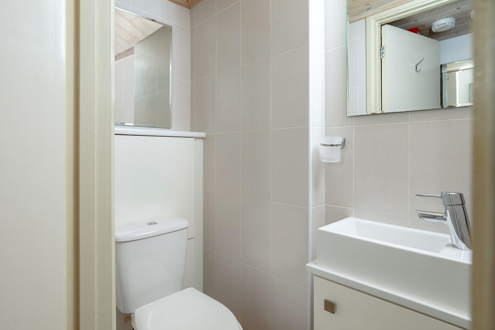 Guests will find the cloakroom located between the bedrooms and living area. 