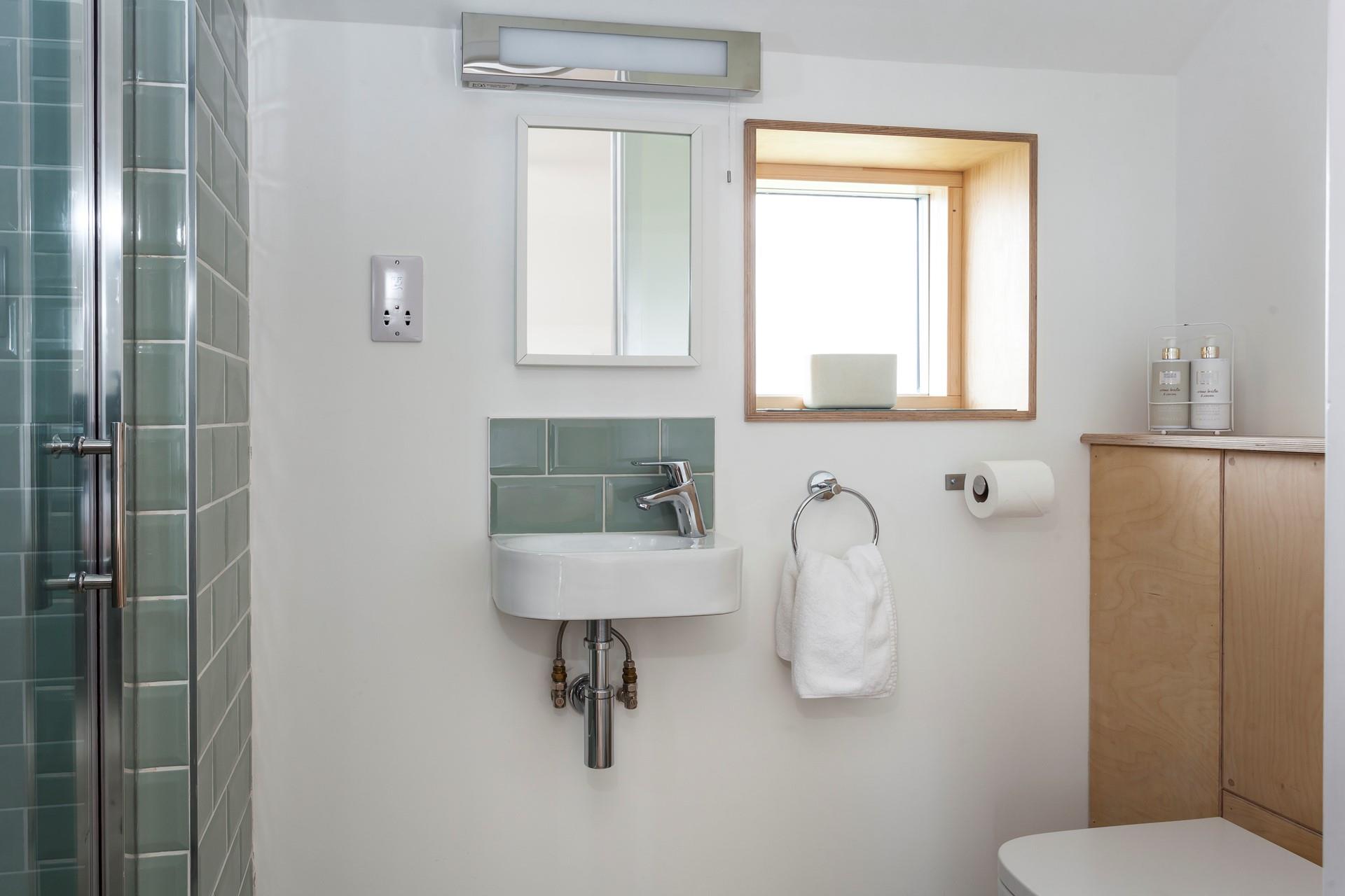 We love the colour of the tiles in the en suite shower room. 
