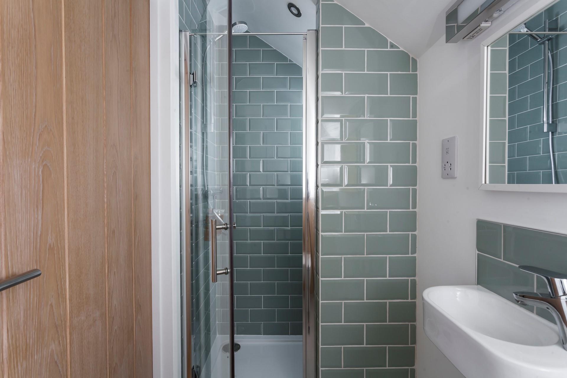 Compact but spacious, the en suite shower room offers privacy and convenience. 
