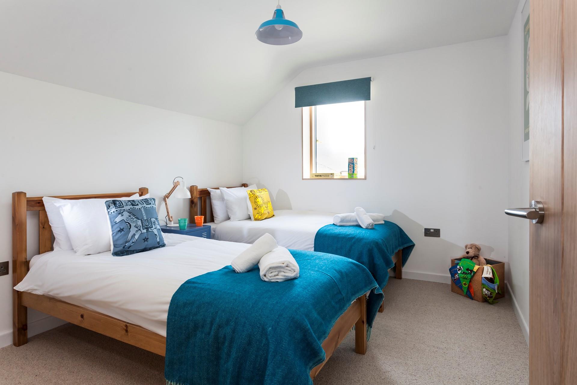 The colourful twin bedroom is perfect for children. 