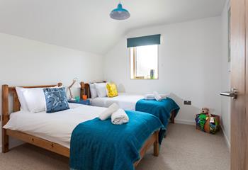 The colourful twin bedroom is perfect for children. 