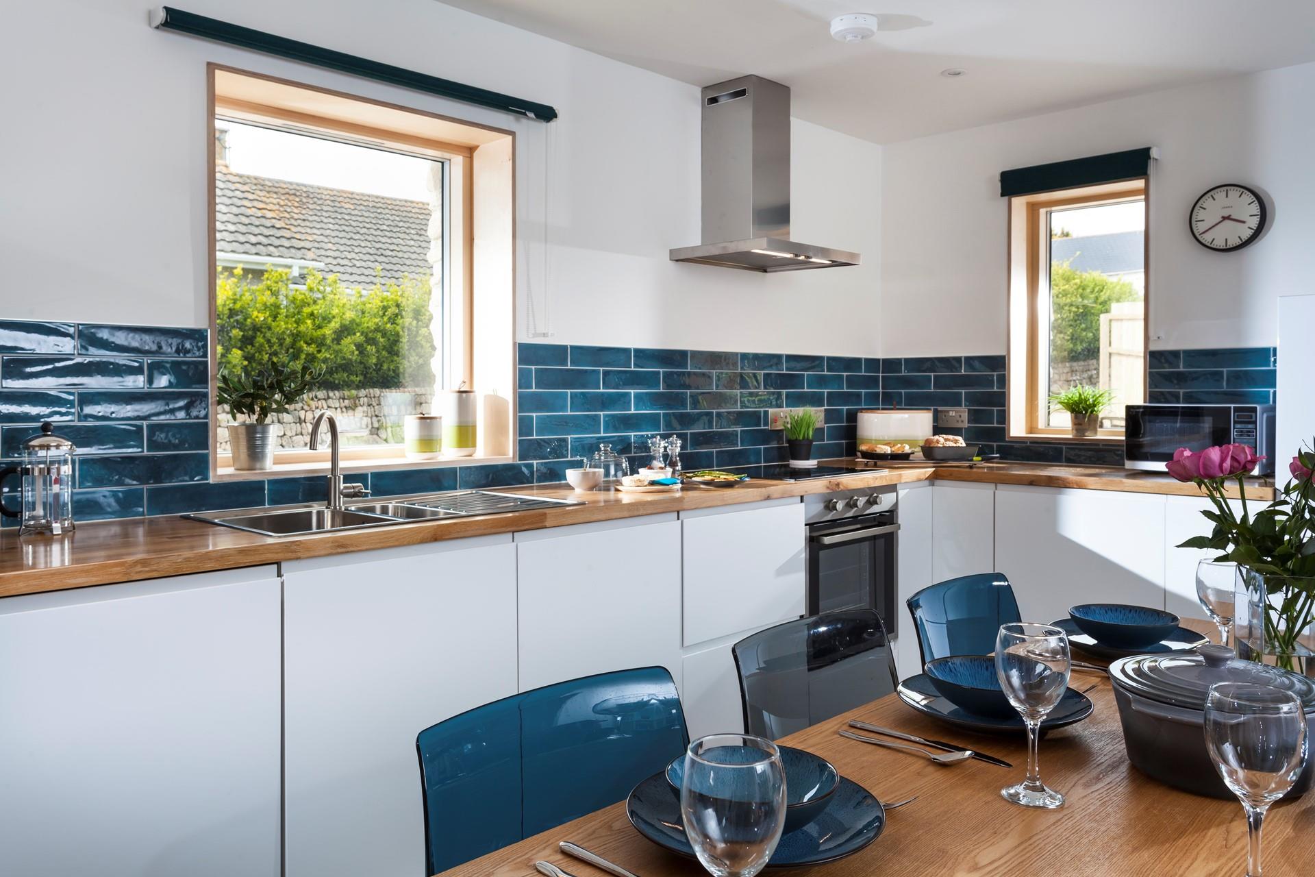 We love the teal tiles and matching chairs and crockery. 