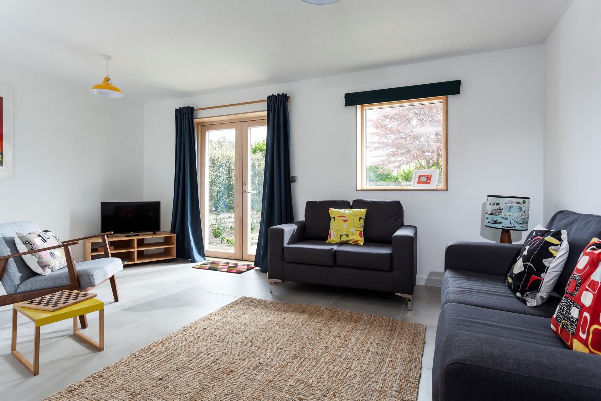 Bright and spacious, the sitting room is the perfect place to unwind after a busy day exploring west Cornwall. 