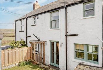 French doors lead from the kitchen and dining area to the garden, ideal for summer barbecues.