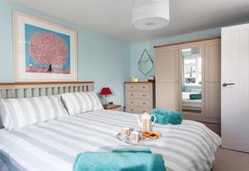 Coastal colours and artwork reflect the property's close proximity to the sea. 