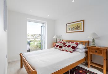 Bedroom 1 benefits from direct access to the balcony; throw open the door and wake up to the sound of the sea in the distance. 