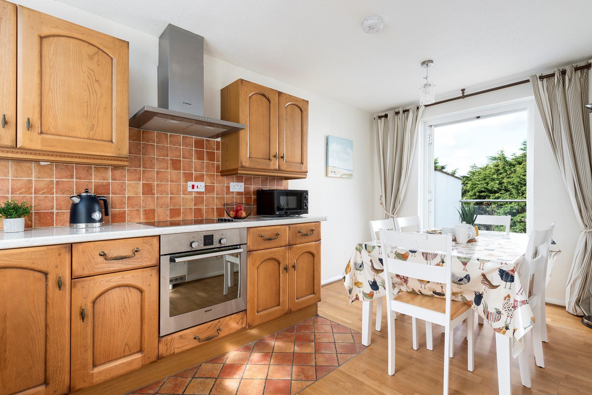 The kitchen/diner features patio doors leading onto the ground floor decking area. 