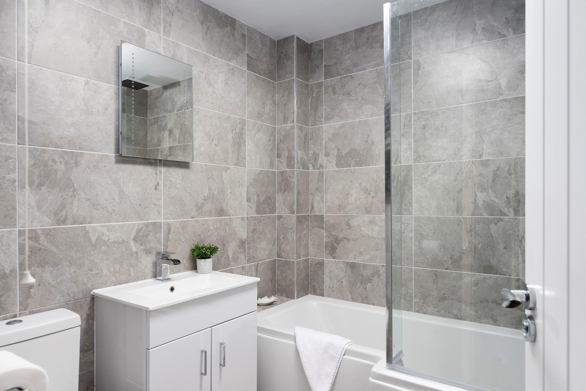 The bathroom has been beautifully finished with a modern and stylish design. 