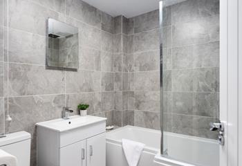 The bathroom has been beautifully finished with a modern and stylish design. 