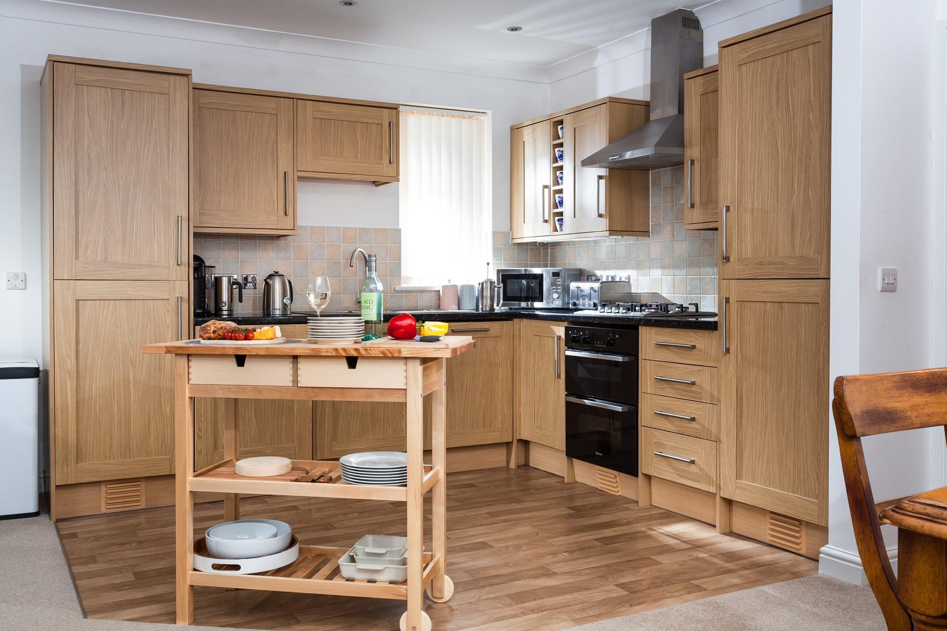 The country-style kitchen is beautifully designed and fully equipped with modern appliances to make whipping up tasty meals a breeze.