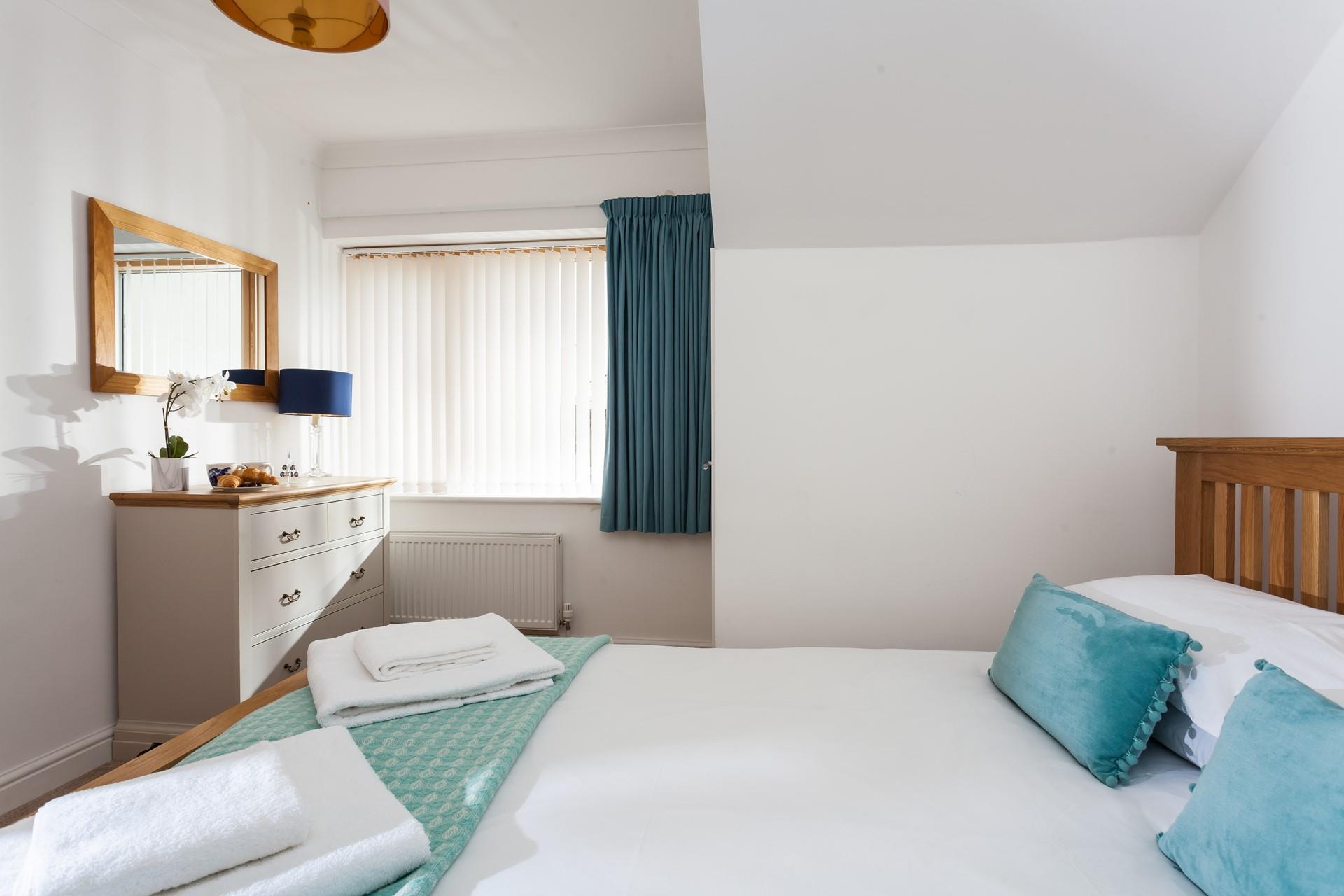 The bedroom is spacious and will provide you with a relaxing base to come back to.