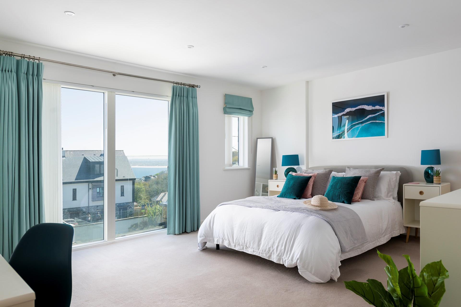 Shades of blue, leafy plants and coastal artwork create a calming oasis in bedroom 1; rest, relax and restore.