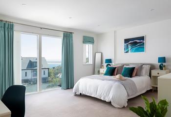 Shades of blue, leafy plants and coastal artwork create a calming oasis in bedroom 1; rest, relax and restore.