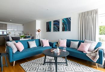 Teal furnishings and stunning artwork perfectly reflect the property's coastal location. 